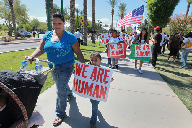 Arizona Protesters with "We Are Human" signs