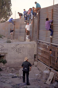 Immigrants caught climbing border fence