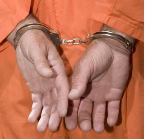 hands in cuffs - orange jumpsuit