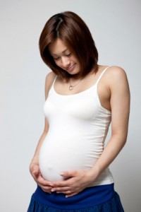 smiling, pregnant Asian woman