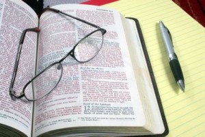 Bible, glasses, pen and paper